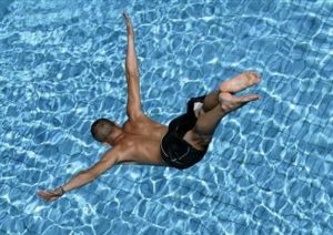man-diving-into-blue-water.jpg