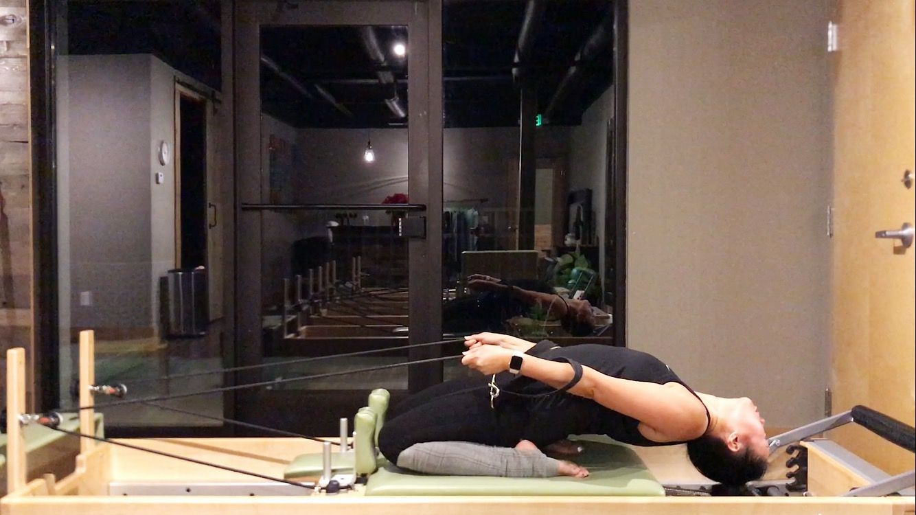 Pilates reformer thigh stretch with arch
