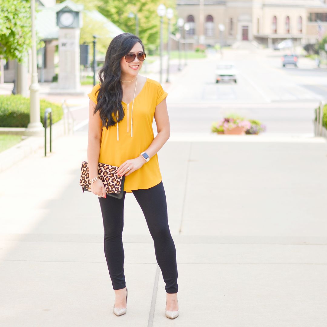 Yellow tunic and leggings, gold pumps, leopard clutch