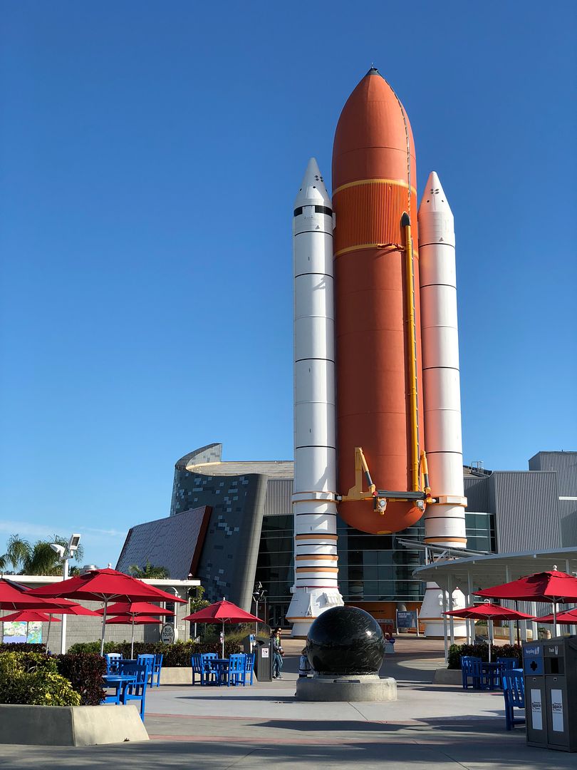 Rocket boosters and orange tank outside the home of the Atlantis